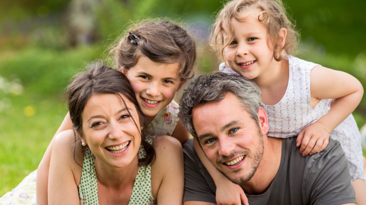 Kinder und Erwachsene draußen auf einer Wiese