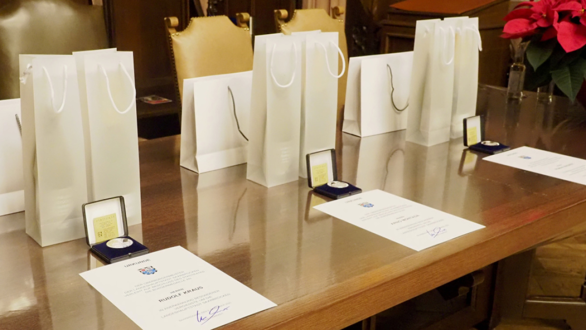 Medaillen, Urkunden und Präsente auf einem Tisch im Festsaal