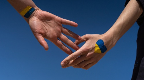 Hände mit ukrainischer Flagge