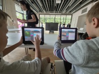 Kinder programmieren mit Dozenten an Tablets