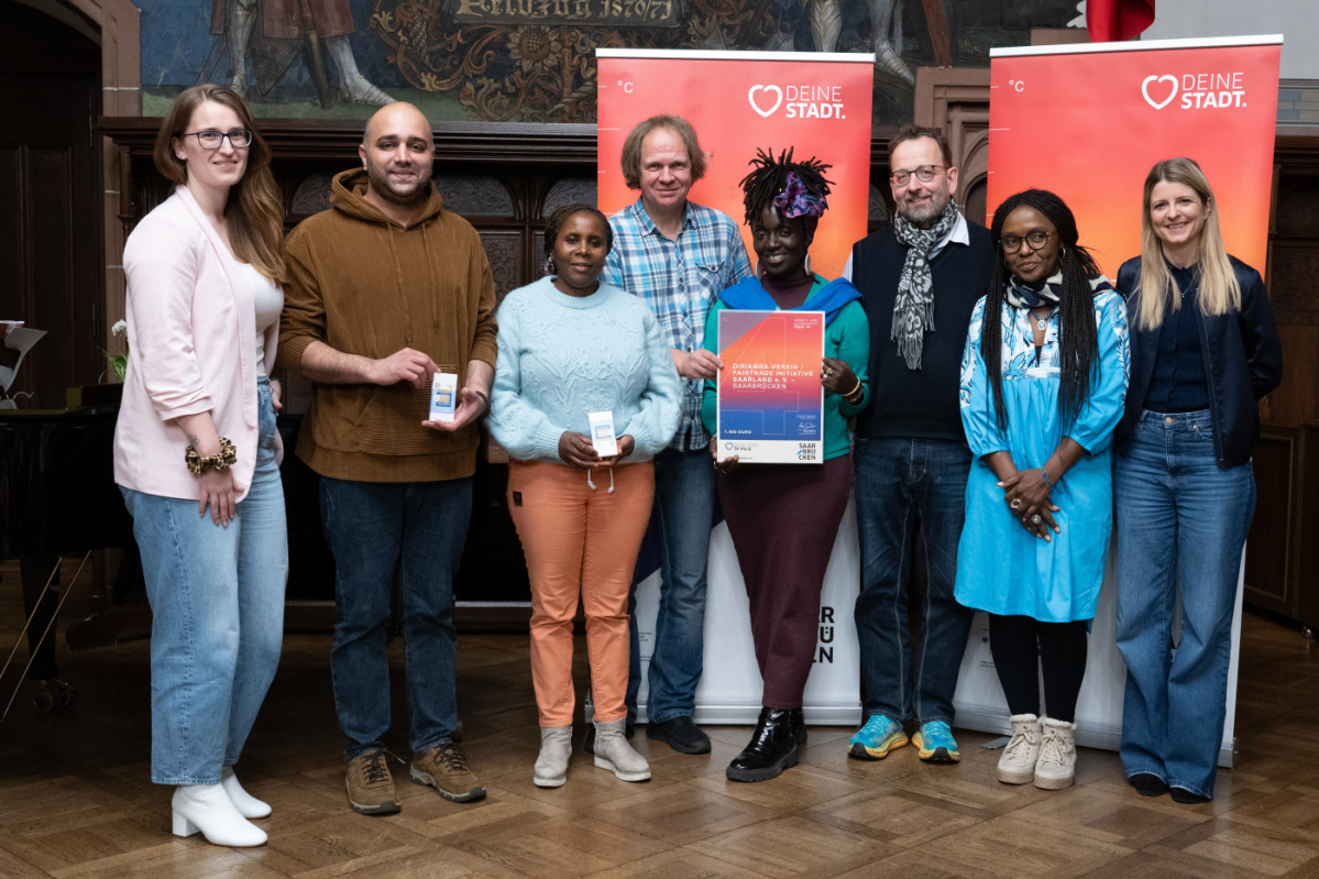 Preisträgerinnen und Preisträger halten Urkunde in Kamera und lächeln