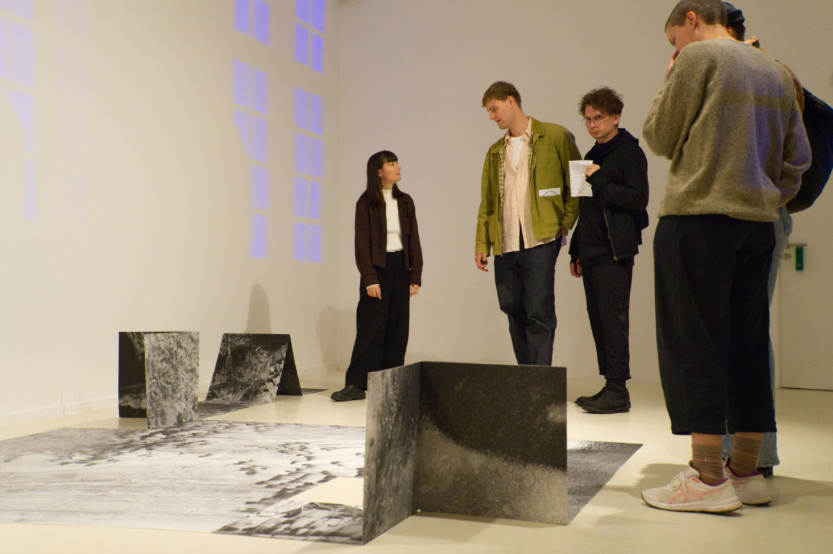 Menschen stehen um ein Bild herum und betrachten es